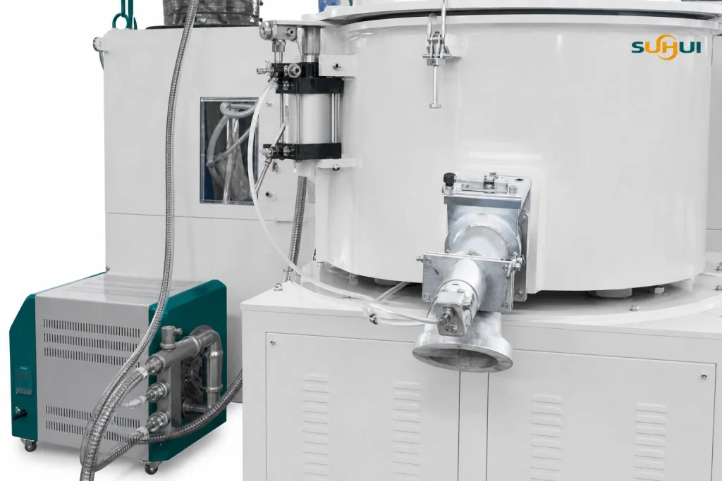High speed mixer pneumatic discharge valve detail with outlet port pipe connections and lower machine body